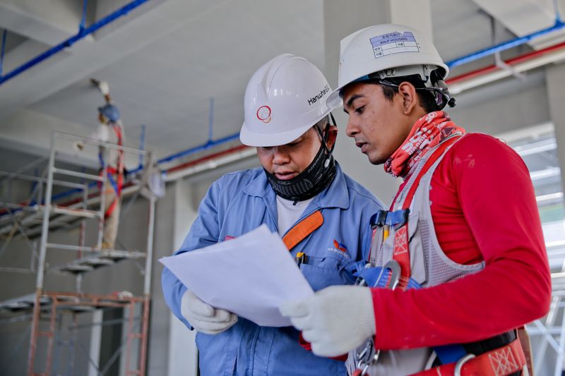 Roofing professionals at work on flat roof project